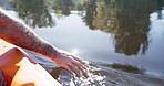 Sailing, boat and hands in the water of a lake for travel, adventure and vacation. Peace, nature and a person on a river in summer for a holiday, freedom or calm in the ocean for an activity