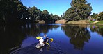 Nature, camping and drone shot of men in kayak together, summer adventure and lake for sports, fun and hobby. Rowing boat, canoe and friends on river with trees, water and freedom on outdoor vacation