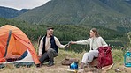 Couple, outdoor camping and help with tent, cable and happy by lake, mountains and forest for holiday. Man, woman and pitch shelter with rope for safety, vacation and teamwork for adventure in bush