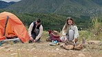 Couple, campfire and set up tent in nature for vacation, holiday and travel outdoor. Camping, lake and happy man and woman at river together for adventure, hiking and trekking in the countryside