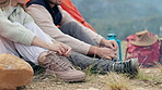 Couple, tie and shoes at camp in outdoor or closeup for vacation with bonding or conversation. Hike, man and sitting with woman with discussion in nature with boots for travel, adventure or trekking.