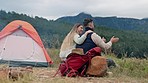 Talking, hug and a couple camping in nature for a date, happiness and a holiday together. Happy, care and a young man and woman speaking while on an outdoor vacation in the countryside for travel