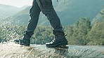Walking, shoes or man hiking on in nature adventure to explore outdoors for camping on holiday vacation. Boots, closeup or legs of hiker trekking on water with footwear for travel, break or journey  