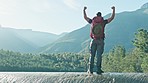 Success, hiker or man in celebration on mountain peak in nature adventure walking outdoors on journey. Hiking, view or back of excited traveler with hands up for hope or goal achievement in forest