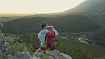 Hiking, mountain and man with backpack, water bottle and relax on outdoor adventure with freedom in nature. Trekking, rock climbing and hiker sitting for drink break, horizon and motivation with view