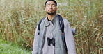 Walking, climbing or happy man hiking by lake in nature to explore outdoors on holiday or adventure. Traveler, smile or Asian hiker with backpack for travel, break or journey by mountains to relax 