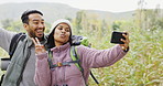 Couple, hiking and a peace sign in nature for a selfie, camping update or video call. Happy, playful and a man and woman taking a photo while on holiday in the countryside for a trekking memory