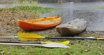 Kayak boat, rain and nature with adventure and journey on river with paddle for fitness and exercise. Outdoor, rowing and equipment for workout for water sport with travel on lake on holiday in woods