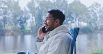 Happy man, camping and phone call in nature, lake or woods communication and outdoor conversation at travel location. Talking, funny and mobile chat of person or camper relax in chair by forest river