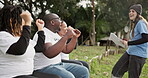 Winner, volunteer and a camping woman reading documents to her team outdoor in the forest for motivation. Team building, support and camp counselor group cheering together during a meeting in nature