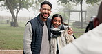 Couple, smile and photographer at park to take picture, bonding and having fun on holiday in winter fog. Interracial, man and woman taking photo on vacation for happy memory, love and care in nature