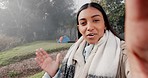 Nature, vlog and young woman on a camp in the forest for an outdoor weekend trip or adventure. Talking, greeting and portrait of a Indian female influencer live streaming on a holiday or vacation.