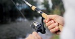 Hands, reel fishing rod and lake for catch, sport or hobby in nature, forest or holiday with tools for food. Person, fisherman and closeup for fish, river or woods for sustainability in environment