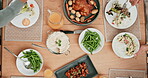 Meal, hands and table in top view with family during supper for nutrition in home on weekend. Hungry, people and food with group for lunch together with chicken, juice and salad for celebration.