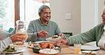Senior man, family and talking while eating food in house for social gathering lunch, holiday and celebration lunch. Smile, group and happy elderly person with healthy meal in home for dinner hosting