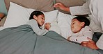 Night, parent and children in bed to sleep with comfort, peace and love in a family home. Hands of a mother to touch kids or sisters while in bedroom with the light off for rest and development