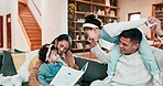 Family, reading a book and together on a sofa at home to relax, bond and playing for quality time. Happy man, woman or parents and children in living room for happiness, love and care while learning