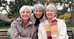 Senior, women sitting and friends face in park with retirement smile in a garden. Nature, portrait and hug with elderly female people on vacation in woods feeling happy from bonding and freedom