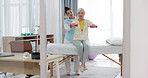 Physiotherapy, senior woman with dumbbell and nurse in clinic for rehabilitation, fitness and support in healthcare exercise. Physical therapy, help and training with a physiotherapist in hospital