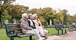 Happy, senior friends and walking together on an outdoor path or relax in nature with elderly women in retirement. People, talking and sitting for conversation on a park bench in autumn or winter