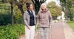 Senior woman, walker and nurse outdoor in a park with healthcare for elderly exercise. Walking, healthcare professional and female person with peace and physical therapy in a public garden with carer