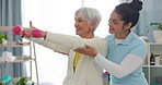 Physiotherapy, senior woman with dumbbell exercise and nurse in clinic for rehabilitation, fitness and support in healthcare. Physical therapy, help and training with a physiotherapist in hospital