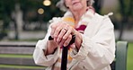 Walking stick, hands and senior woman closeup on a park bench with person with disability. Mobility support, wellness and balance with cane and elderly female person outdoor in a public garden