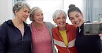 Senior woman, exercise group and selfie with personal trainer in home for smile, web blog and teamwork. Elderly lady, team memory or fitness coach for photography, profile picture or social media app