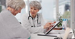 Senior doctor, tablet and talking to patient for healthcare prescription or diagnosis at hospital. Mature medical professional consulting elderly female person on technology for help advice at clinic