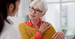 Medical, shoulder pain and a senior woman with her doctor in the hospital, talking during a consultation. Healthcare, insurance or anatomy and a woman patient in a clinic with a medicine professional