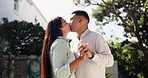 Kiss, couple and dance in backyard for love, affection or bonding together. Man, happy woman and moving with intimate romance, commitment for marriage and holding hands on date on vacation outdoor