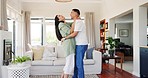 Funny, couple and dance in home for love, care and bonding together in living room. Man, happy woman and moving with intimate romance to music, commitment for marriage and laughing in celebration