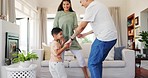 Family, happy and dance with child in home, bonding and having fun time together. Smile, kid and father and mother moving to music, celebration and excited, holding hands and energy in living room