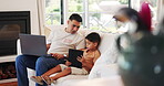 Father, laptop and child with tablet on a sofa in home living room for bonding, care and talking. Technology, kid and dad with computer for remote work on couch, learning and streaming online movie