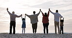 Family, silhouette and holding hands at the beach on a holiday, vacation or people together at sunset with sea or ocean view. Travel, love and shadow of group with freedom, celebration or support
