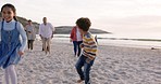 Family, beach and running with parents excited with children having fun with travel outdoor. Holiday, sunset and sea adventure with kids, mom and dad together on vacation by the ocean with smile
