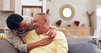 Laugh, hug and senior couple on a sofa talking, bond and happy in their home together. Smile, love and old people embrace in a living room with conversation, romance and enjoy retirement or weekend
