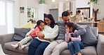 Family, parents and girl children jumping onto the sofa in the living room of their home for hugging or bonding. Excited kids, mother and father sitting together for love, trust or support in a house