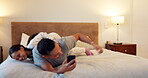 Father, relax and excited kids in bedroom with dad for bonding, playing or talking in home on the weekend. Happy, family and children together for quality time or jumping on the bed in morning