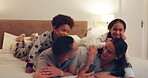Family, relax and excited kids in bedroom with parents for bonding, playing or talking in home on the weekend. Mom, dad and excited children together for quality time or jumping on the bed in morning