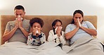 Sick, bed and family blowing their nose while relaxing together with a cold, flu or allergies. Illness, rest and parents in hayfever recovery with their children in the bedroom of their modern house.