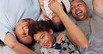 Above, playful and a family on the bed for tickling, love and comedy in the morning. Happy, laughing and parents playing with funny children in a home bedroom for bonding, care and crazy together