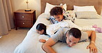 Father, relax and excited kids play in bedroom with dad on holiday or wake up with energy on the weekend. Happy, family and children together for quality time or jumping on the bed in morning