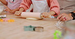 Dough, rolling pin and hands of child baking dessert, food or prepare cookie, flour or ingredients ingredients with parents support. Kitchen chef, closeup and young child learning home cooking skills