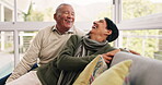 Funny, senior couple and relax on sofa with love in lounge, living room or happiness in marriage and talking in quality time together. Happy, elderly woman and man laugh on couch in home in Mexico