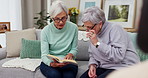 Reading, book club and senior woman friends on a sofa in the living room while reading a story together. Retirement, conversation and hobby with elderly women enjoying a fiction novel in a home