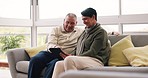 Happy, senior and a couple with a tablet on the sofa for social media, app or the internet. Relax, website and an elderly man and woman typing on technology, streaming and reading information