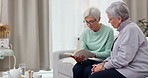 Reading, book club and elderly woman friends on a sofa in the living room while reading a story together. Retirement, conversation and hobby with senior women enjoying a fiction novel in a home
