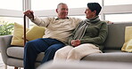 Funny, conversation and senior couple relax on sofa in lounge, living room or happiness in marriage with quality time together. Happy, elderly woman and man talking and laughing on couch in home