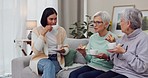 Friends, sofa and women visit in home for conversation, discussion and talking for relationship. Happy, living room and female people on couch with tea for bonding, quality time and relax together